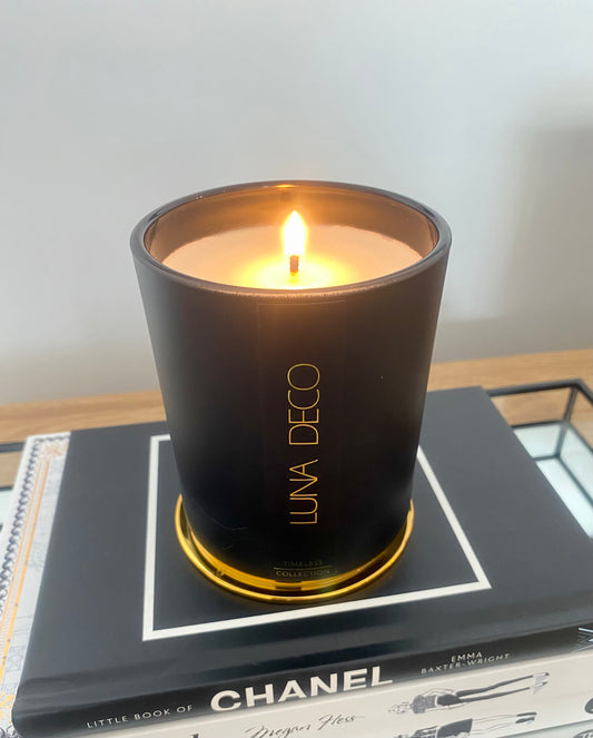 Luna Deco black matte candle on top of a Chanel book, home decor ideas, minimalist style, Australian made soy candle, cozy home, home fragrance, calm and relax, Hand-poured soy candles, clean and fresh burn, perfect gift, treat to yourself, stunning decoration piece,