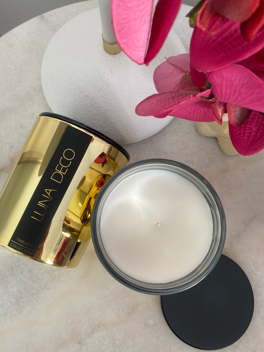 Two gold candles with LUNA DECO label on bedside table with decorative flowers.
Home decor ideas, minimalist style, Australian made soy candle, cozy home, home fragrance, calm and relax, hand-poured soy candles, clean and fresh burn, perfect gift, treat to yourself, stunning decoration piece,