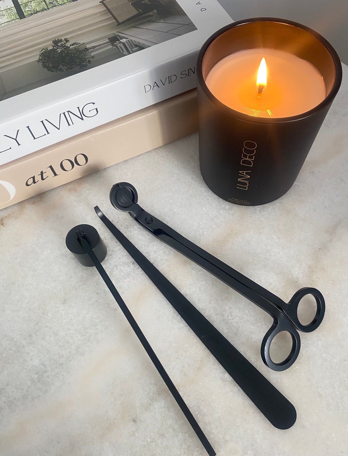 Black candle snuffers, trimmer, and dipper on a marble surface with a lit candle and book in the background.
Candle essentials, candle accessories, 
must-have for every true candle lover - designed to enhance the longevity, beauty and ritual pf your candle. 
Luna Deco