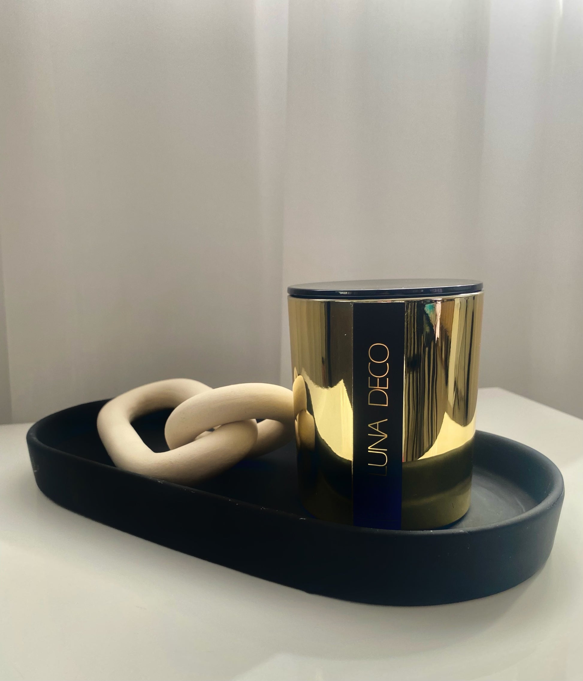 Gold candle with 'UNA DECO' branding on a dark tray against a light background.
Home decor ideas, minimalist style, Australian made soy candle, cozy home, home fragrance, calm and relax, hand-poured soy candles, clean and fresh burn, perfect gift, treat to yourself, stunning decoration piece, 
