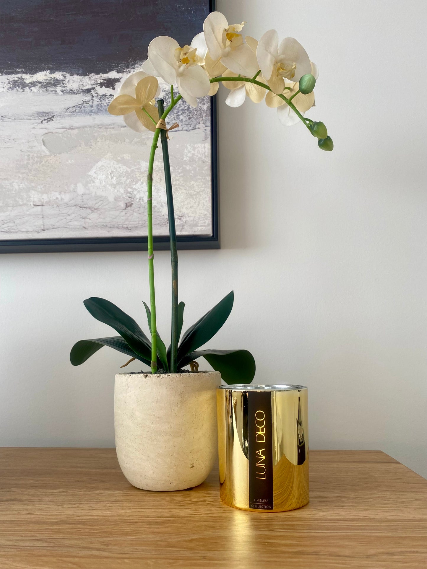 White orchid in a pot on a wooden surface with a gold container labeled 'Luna Deco' .
Home decor ideas, minimalist style, Australian made soy candle, cozy home, home fragrance, calm and relax, hand-poured soy candles, clean and fresh burn, perfect gift, treat to yourself, stunning decoration piece, 
