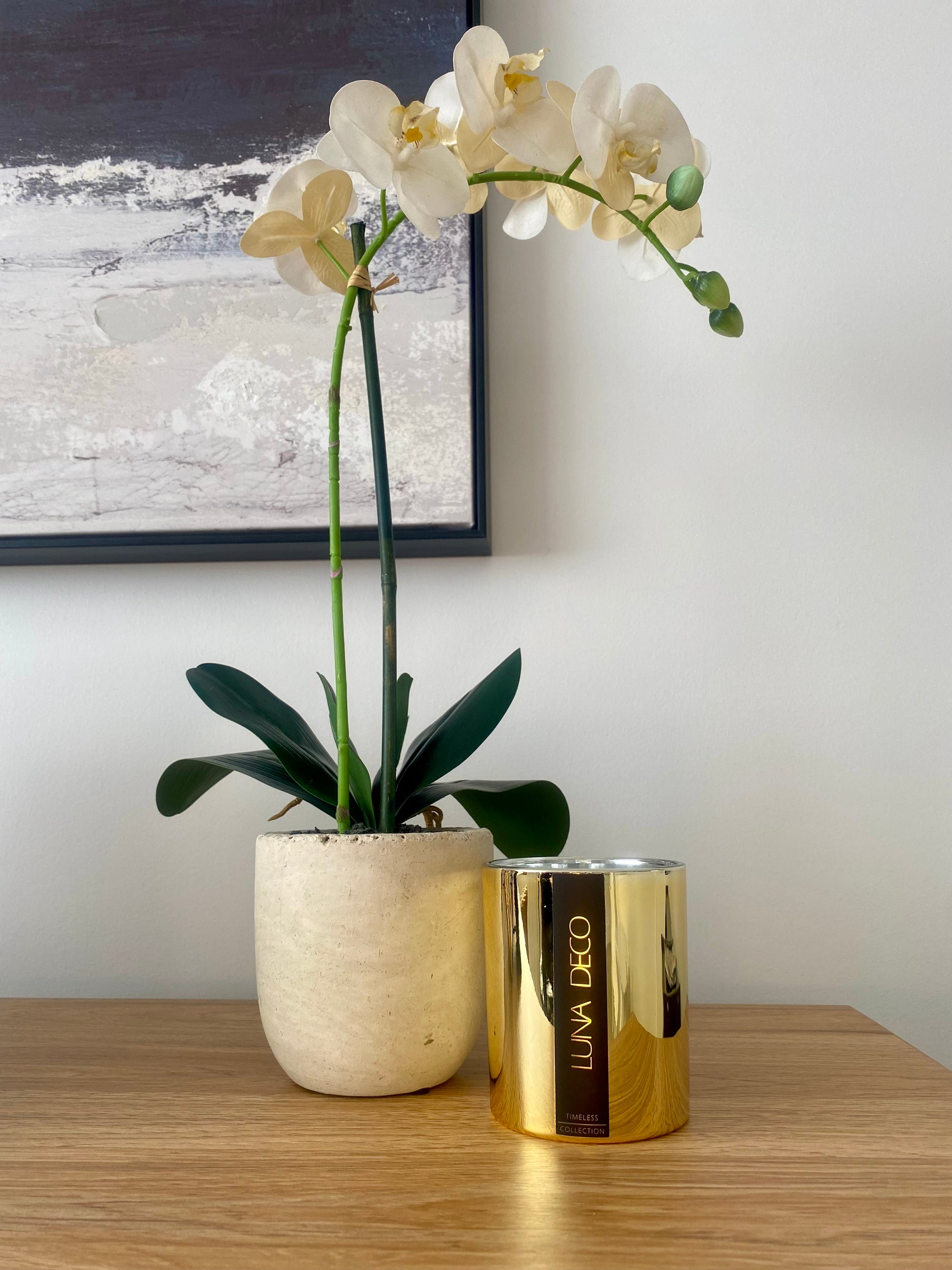 White orchid in a pot on a wooden surface with a gold container labeled 'Luna Deco' .
Home decor ideas, minimalist style, Australian made soy candle, cozy home, home fragrance, calm and relax, hand-poured soy candles, clean and fresh burn, perfect gift, treat to yourself, stunning decoration piece, 