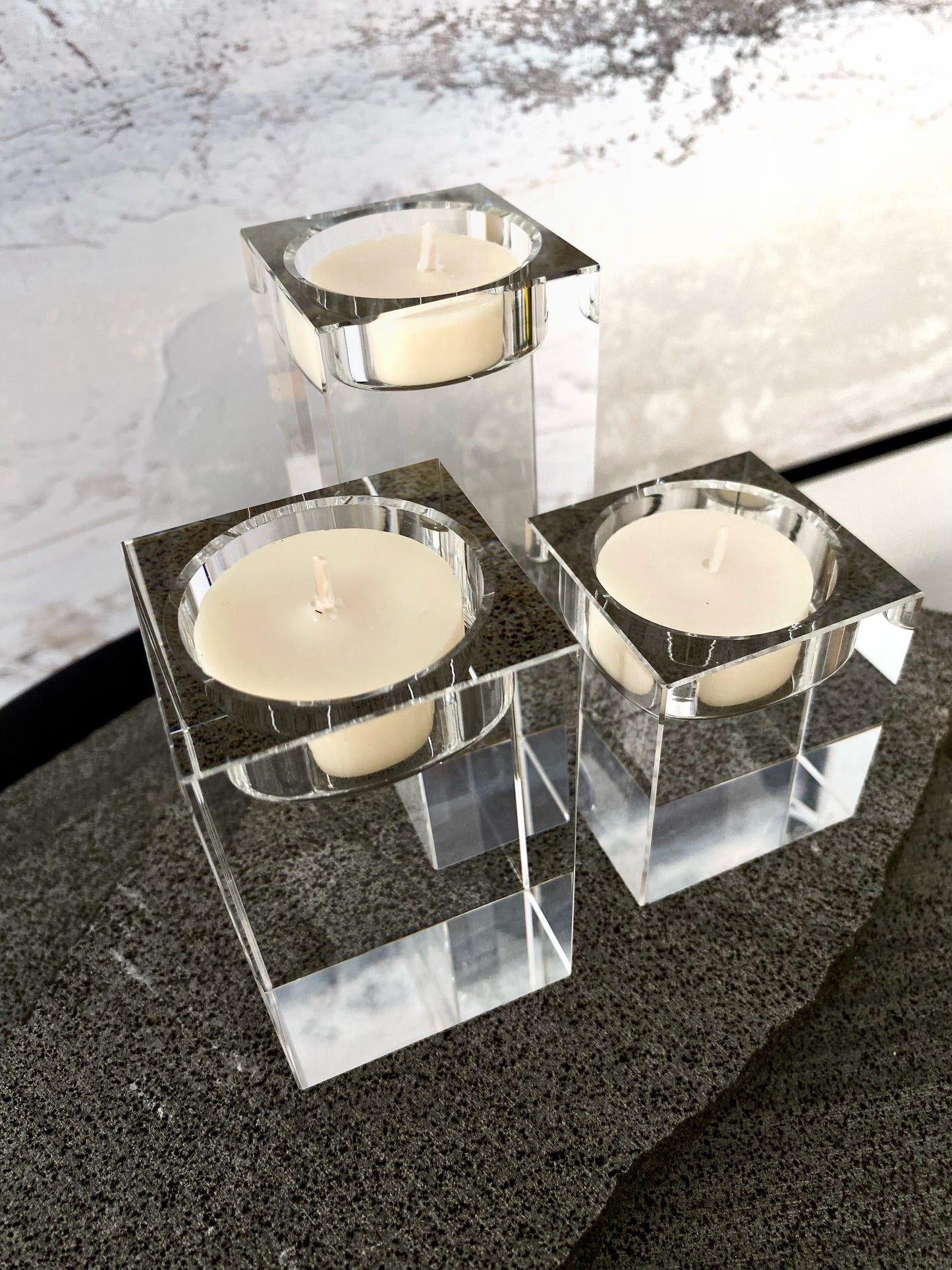 Three square glass candle holders with candles on a dark surface.
Decorative candle holders set. 
Crystal tea light candle holders, set of 3, house decor ideas, gift ideas.
Elegant, minimalist and modern candle holders.
Timeless house decor. Coffee table styling, dinning setting styling. 
Luna Deco
