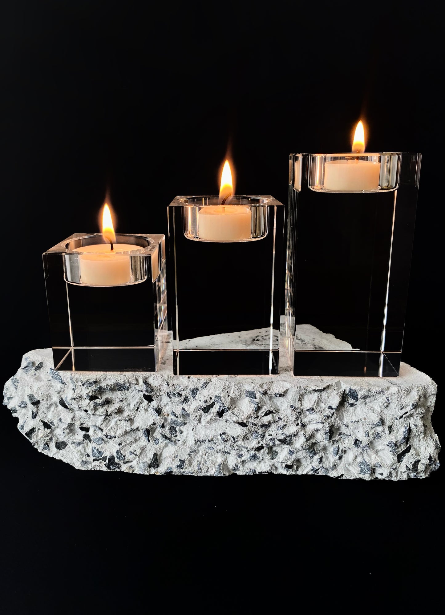 Set of three lit candles in glass holders on a decorative stone base against a black background.
Decorative candle holders set.
Crystal tea light candle holders, set of 3, house decor ideas, gift ideas.
Elegant, minimalist and modern candle holders.
Timeless house decor. Coffee table styling, dinning setting styling. 
Luna Deco